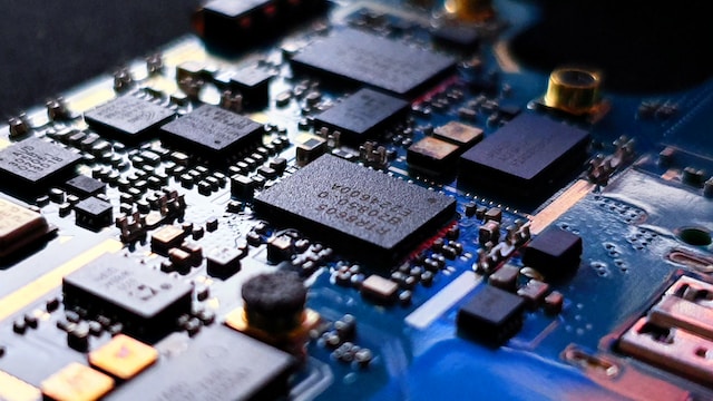 Macro view of a densely populated printed circuit board with
                    surface-mount integrated circuits and connectors